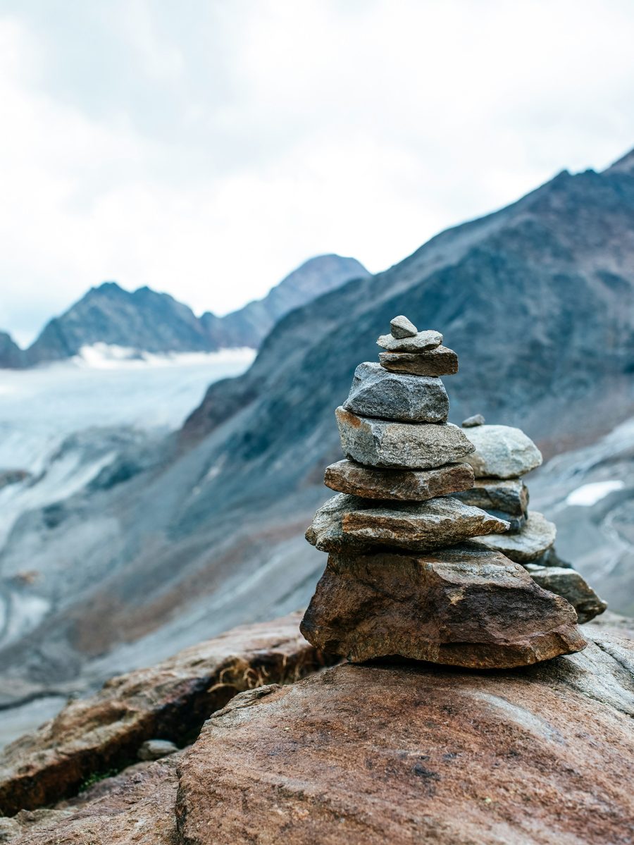 Stones stacked one by one on a mountain trail