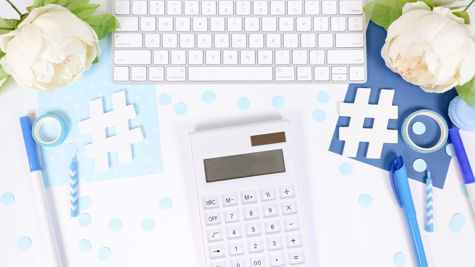 A calculator and keyboard on a desk